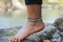 Load image into Gallery viewer, White silver bell boho anklet with small bells and beaded accents, styled on a bare ankle for a bohemian accessory look.